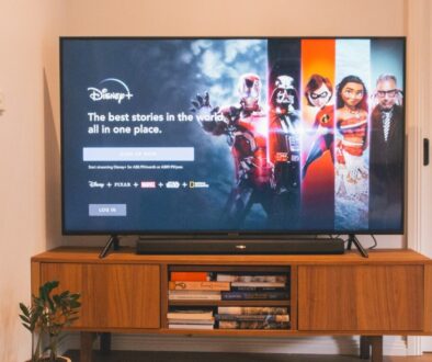 black flat screen tv turned on on brown wooden tv rack