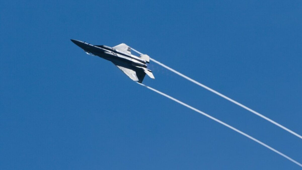 gray jet plane in mid air during daytime