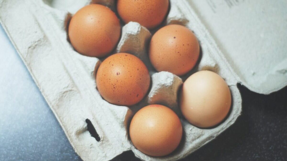 seven brown eggs on tray