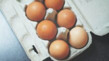 seven brown eggs on tray