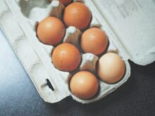 seven brown eggs on tray