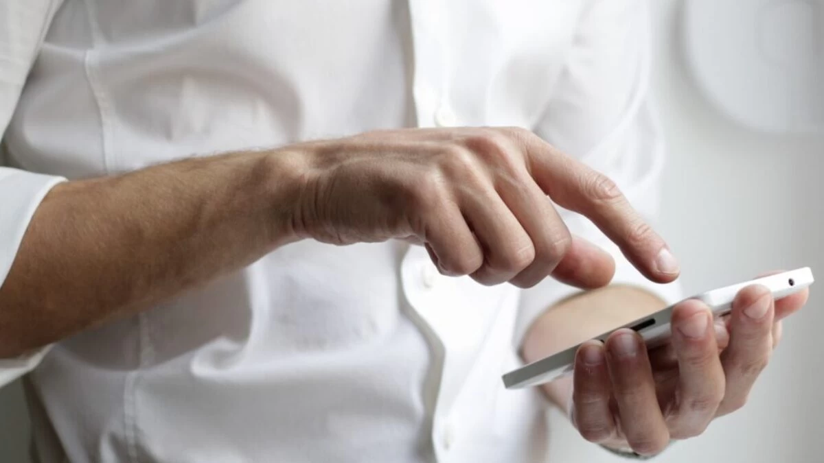 person holding white Android smartphone in white shirt