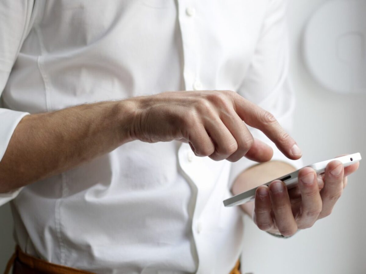 person holding white Android smartphone in white shirt