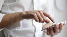 person holding white Android smartphone in white shirt
