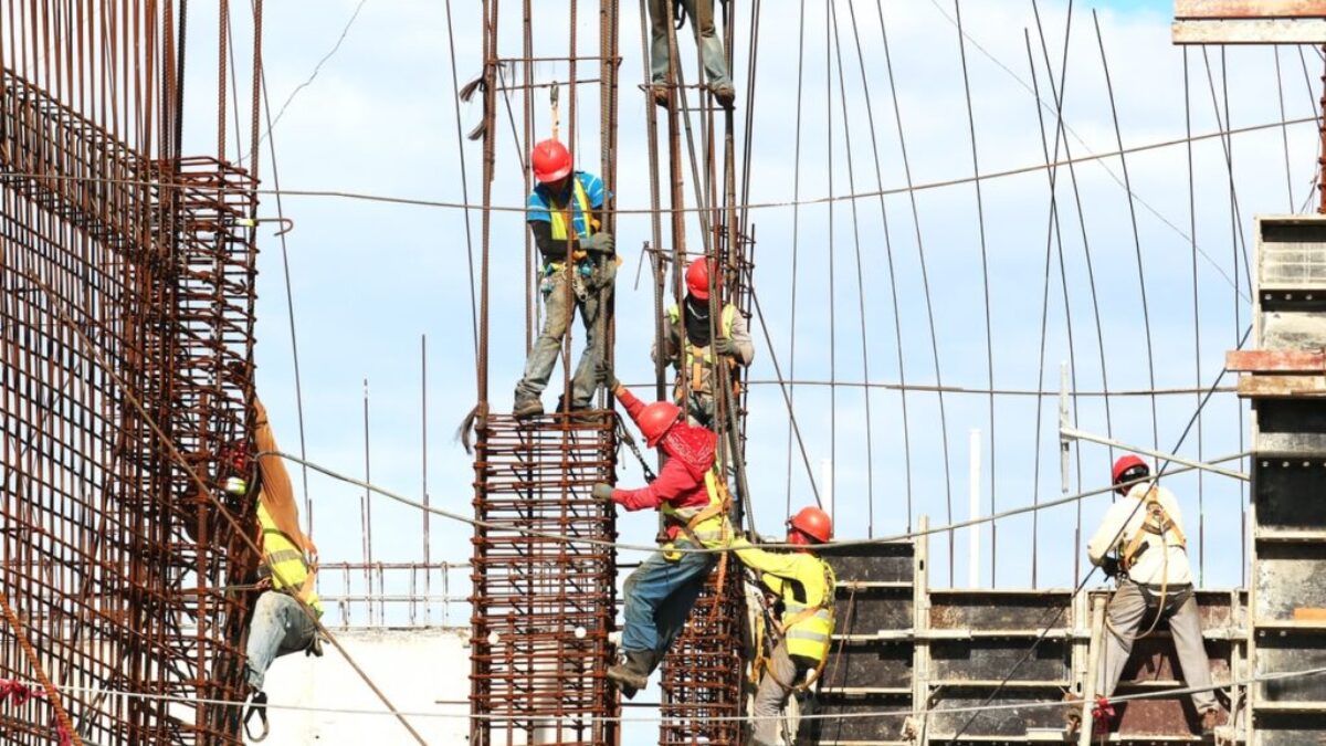 people working on building during daytime