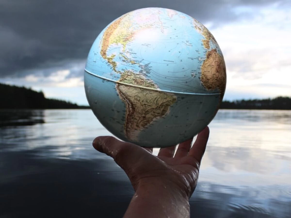 person holding clear glass ball