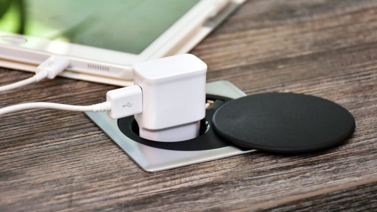 white charger adapter on brown wooden table