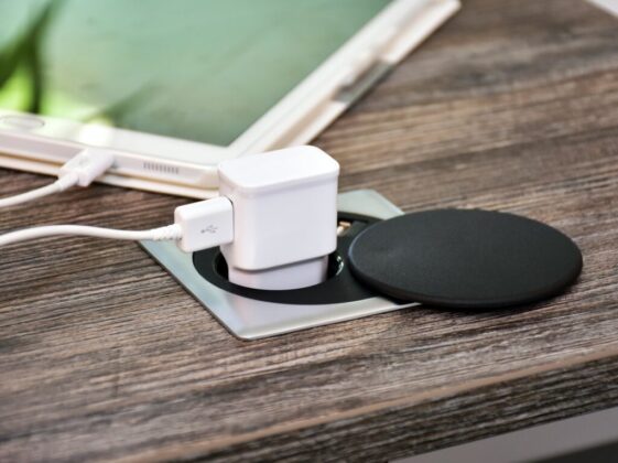white charger adapter on brown wooden table
