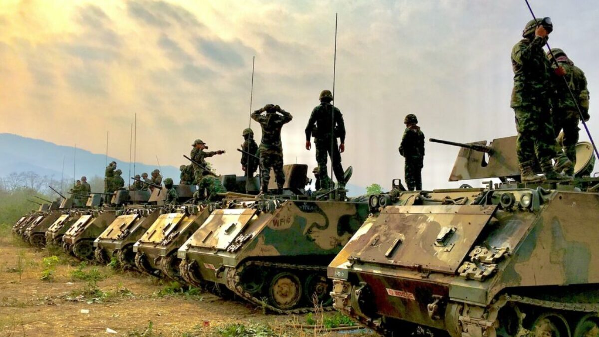 soldiers on top of battle tanks