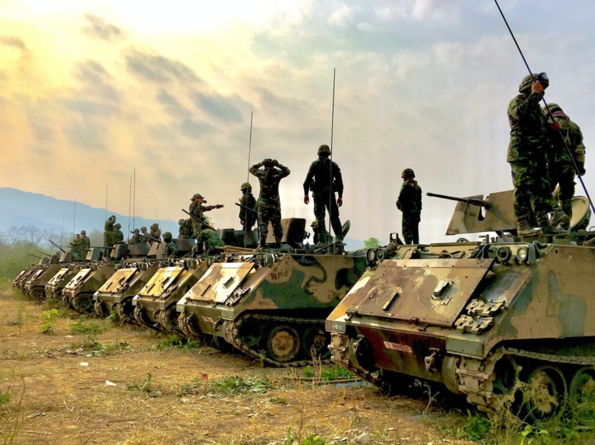 soldiers on top of battle tanks