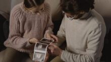A Man and Woman Holding Ultrasound Images
