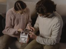 A Man and Woman Holding Ultrasound Images