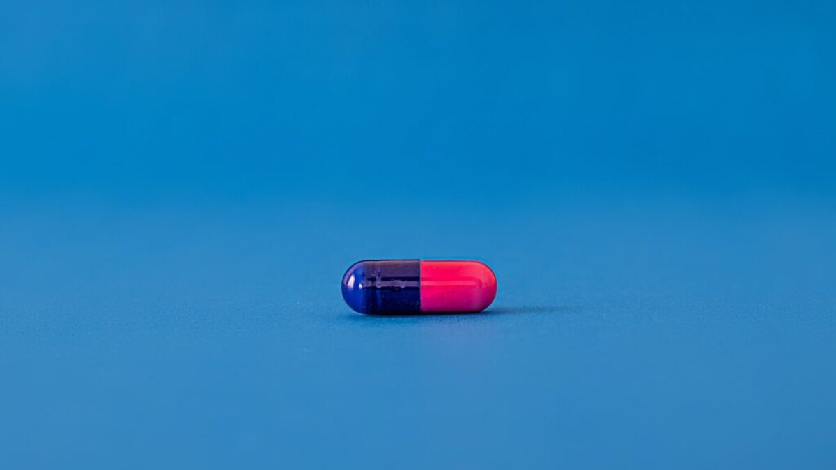red and blue pill on blue surface