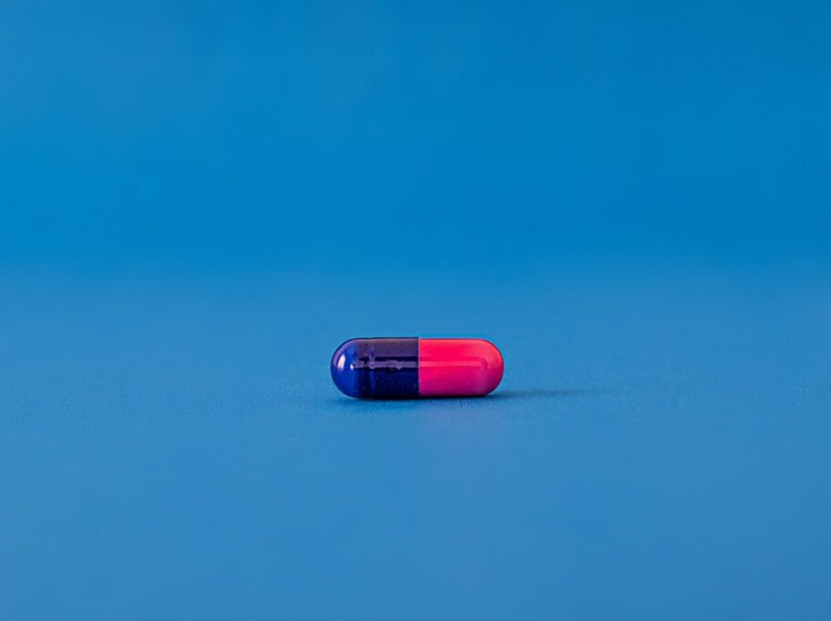 red and blue pill on blue surface