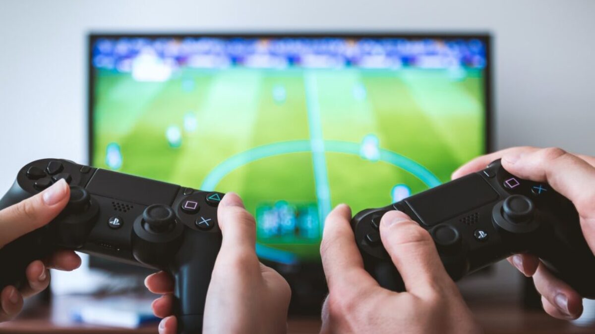 two people playing Sony PS4 game console