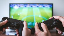 two people playing Sony PS4 game console