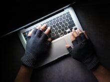 person in black long sleeve shirt using macbook pro