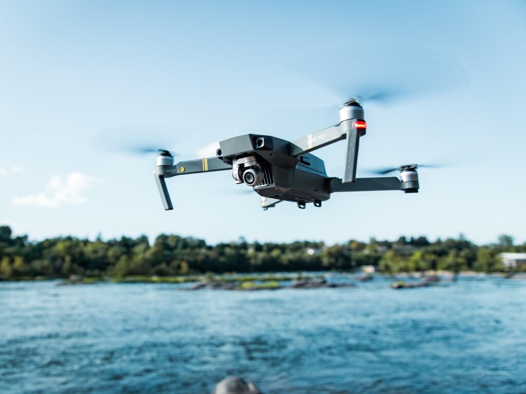 black DJI Mavi quadcopter near body of water