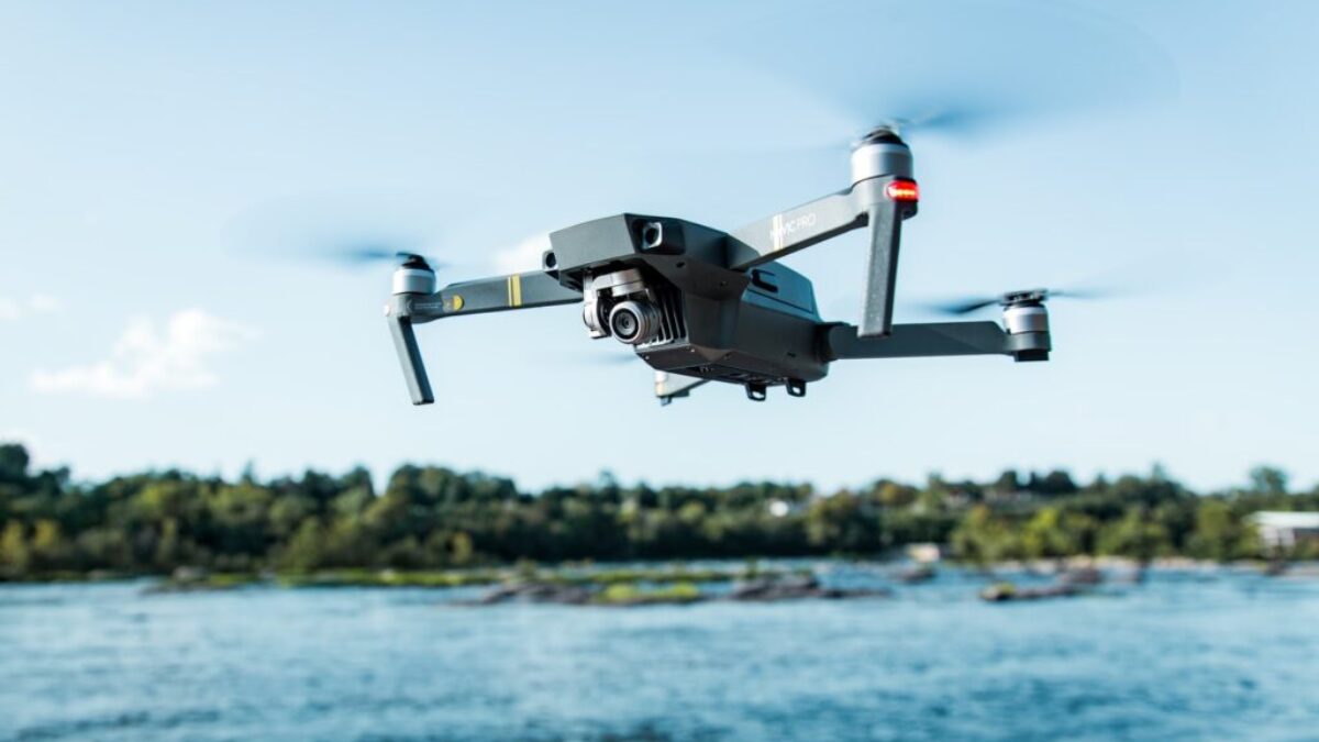 black DJI Mavi quadcopter near body of water