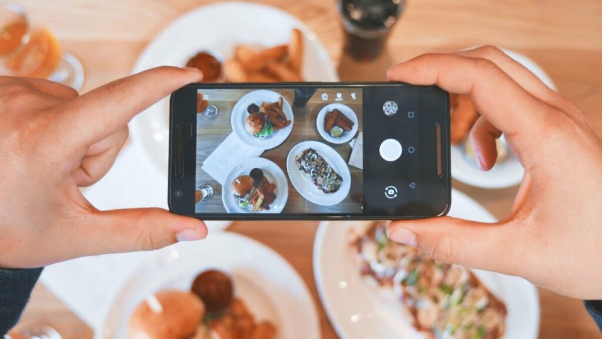 person taking picture of the foods
