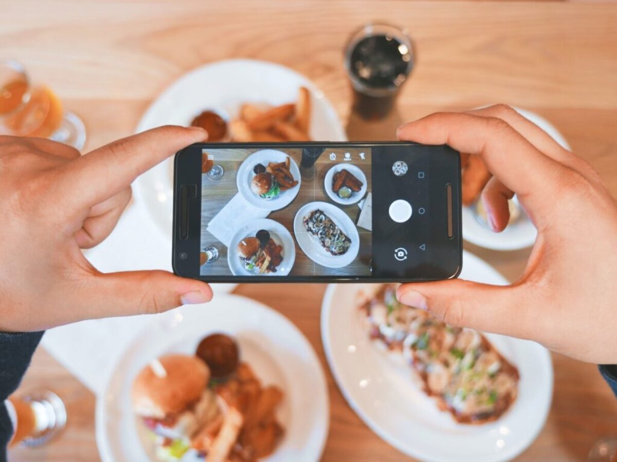 person taking picture of the foods