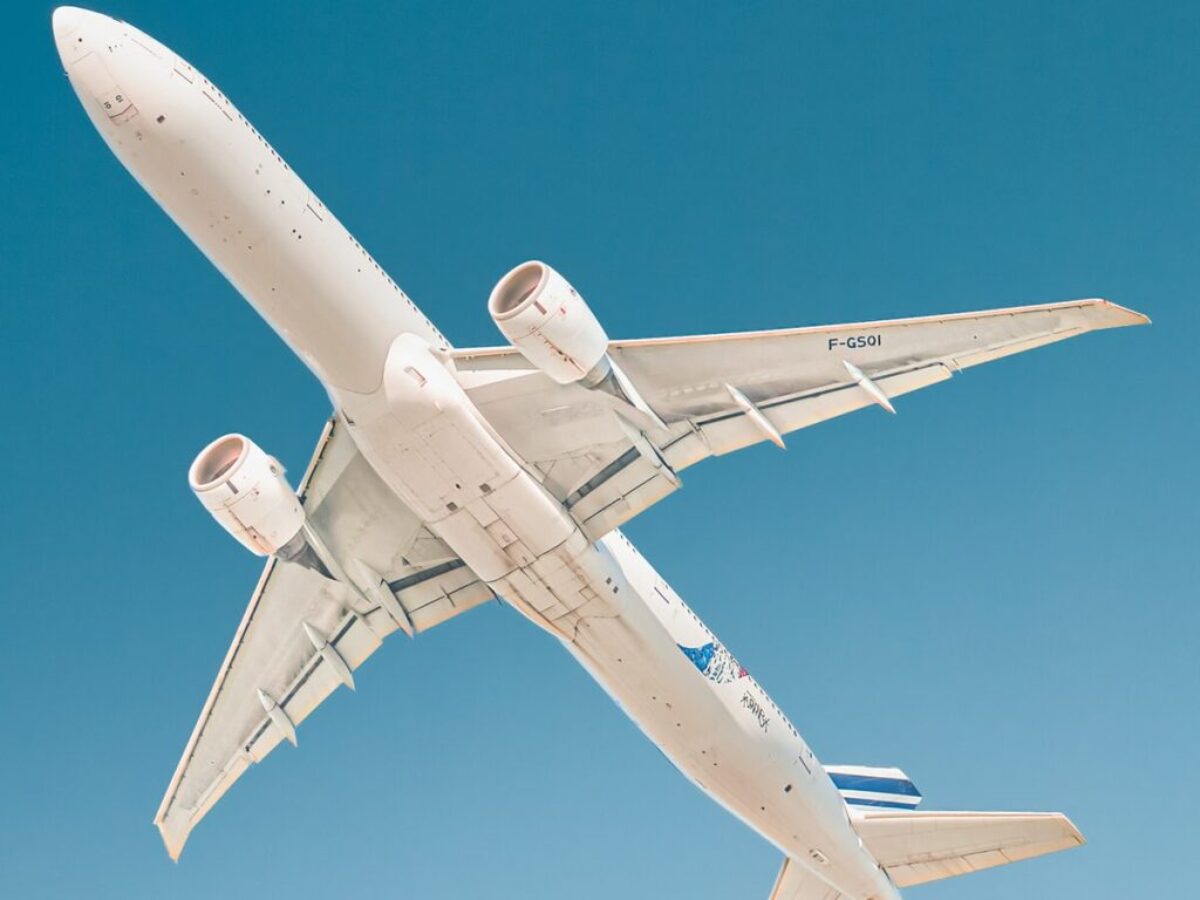 white airplane under blue sky during daytime