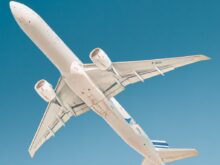 white airplane under blue sky during daytime