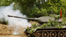 green battle tank on brown soil