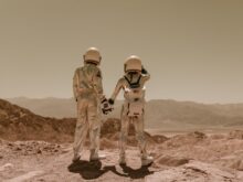 Back View of Astronauts Holding Hands