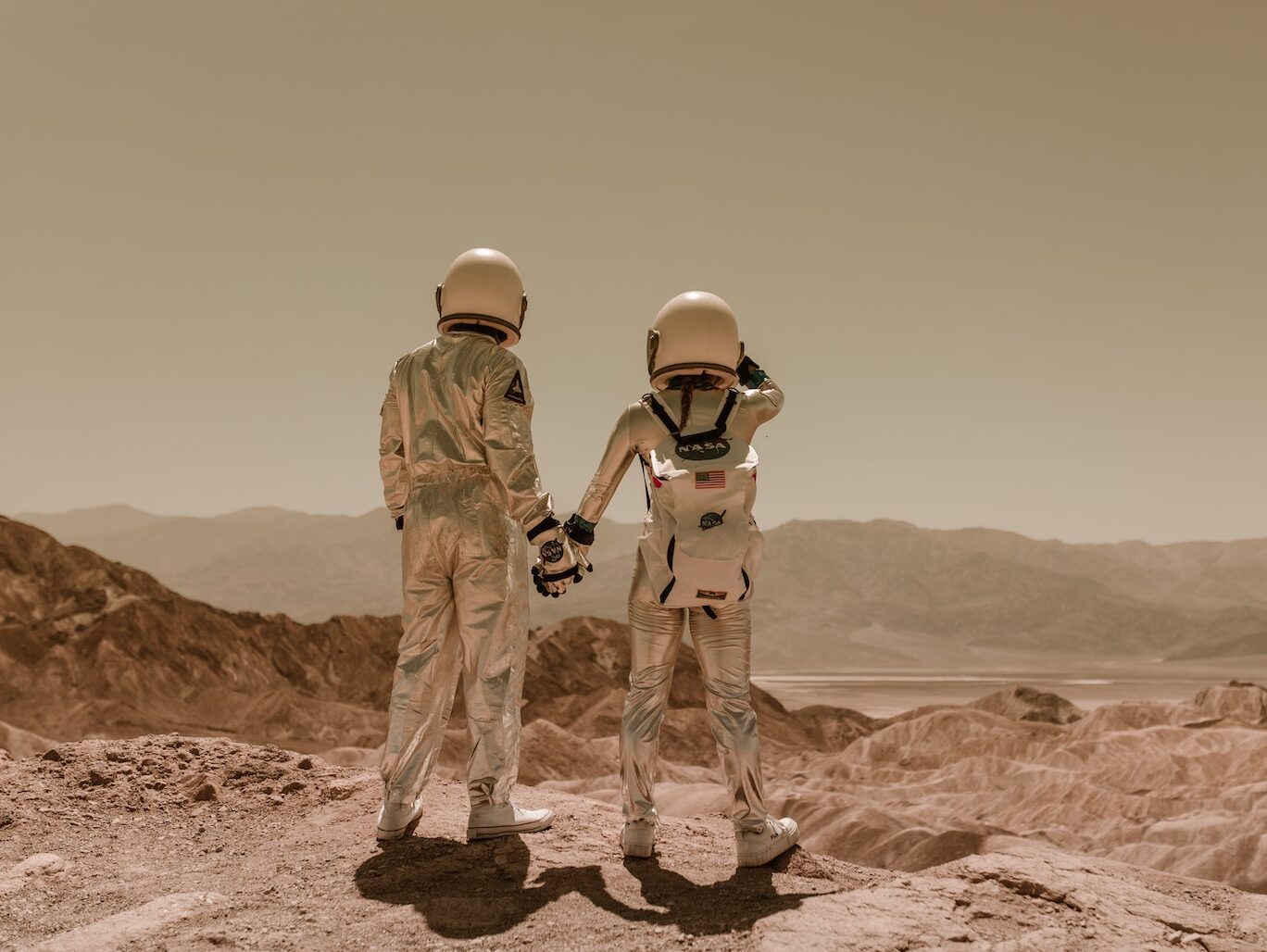 Back View of Astronauts Holding Hands