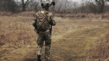 man walking on brown grass field
