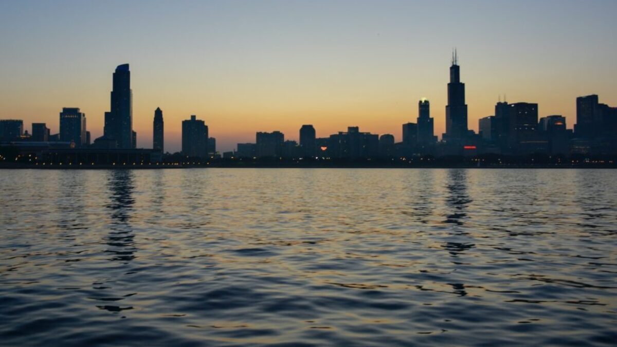 silhouette of city skyline near body of water