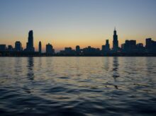 silhouette of city skyline near body of water
