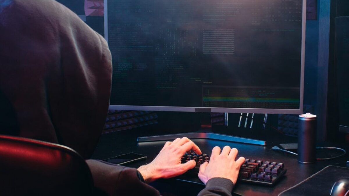 Person in Black Long Sleeve Shirt Playing Computer