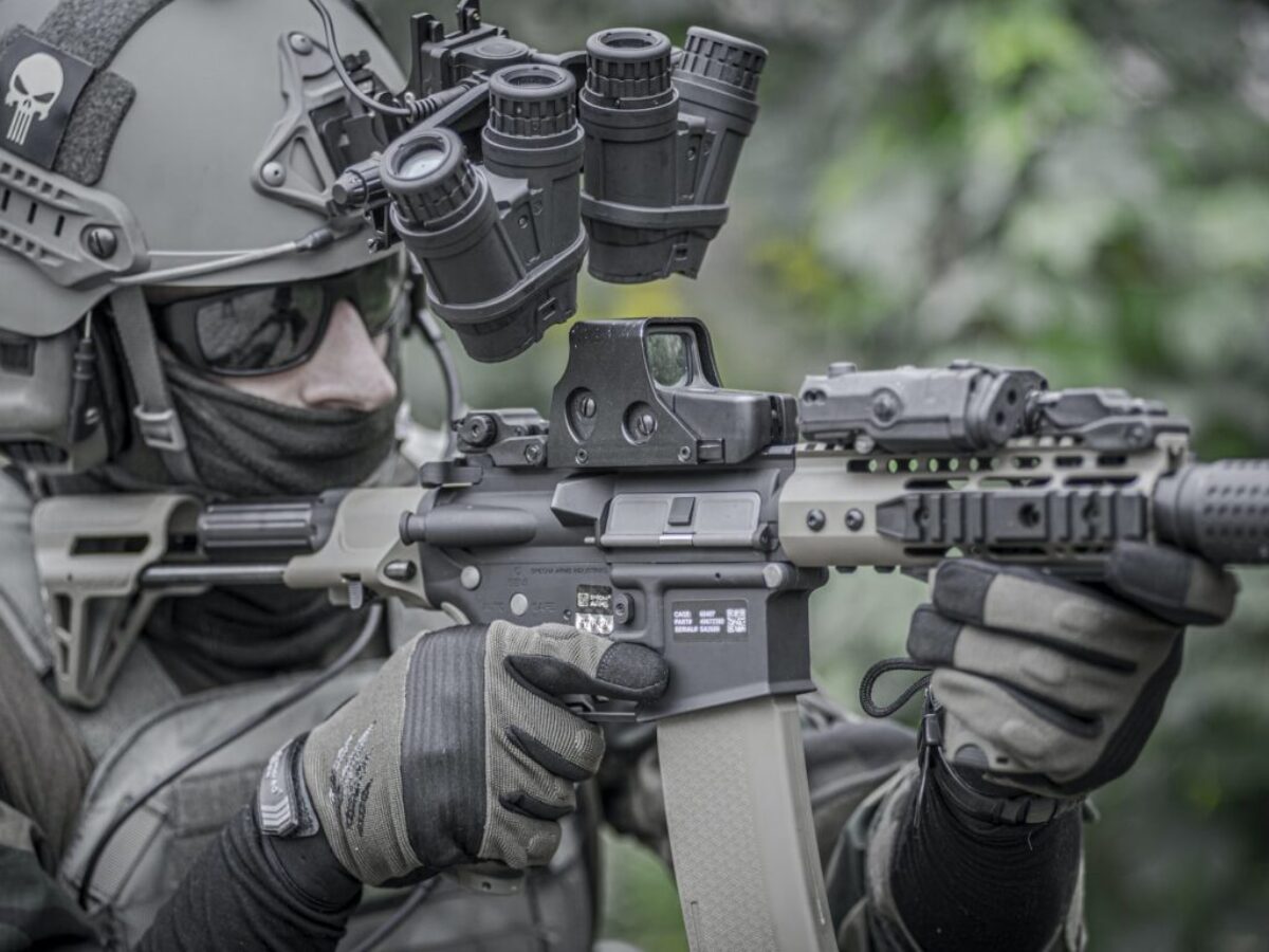 person holding grey and black rifle