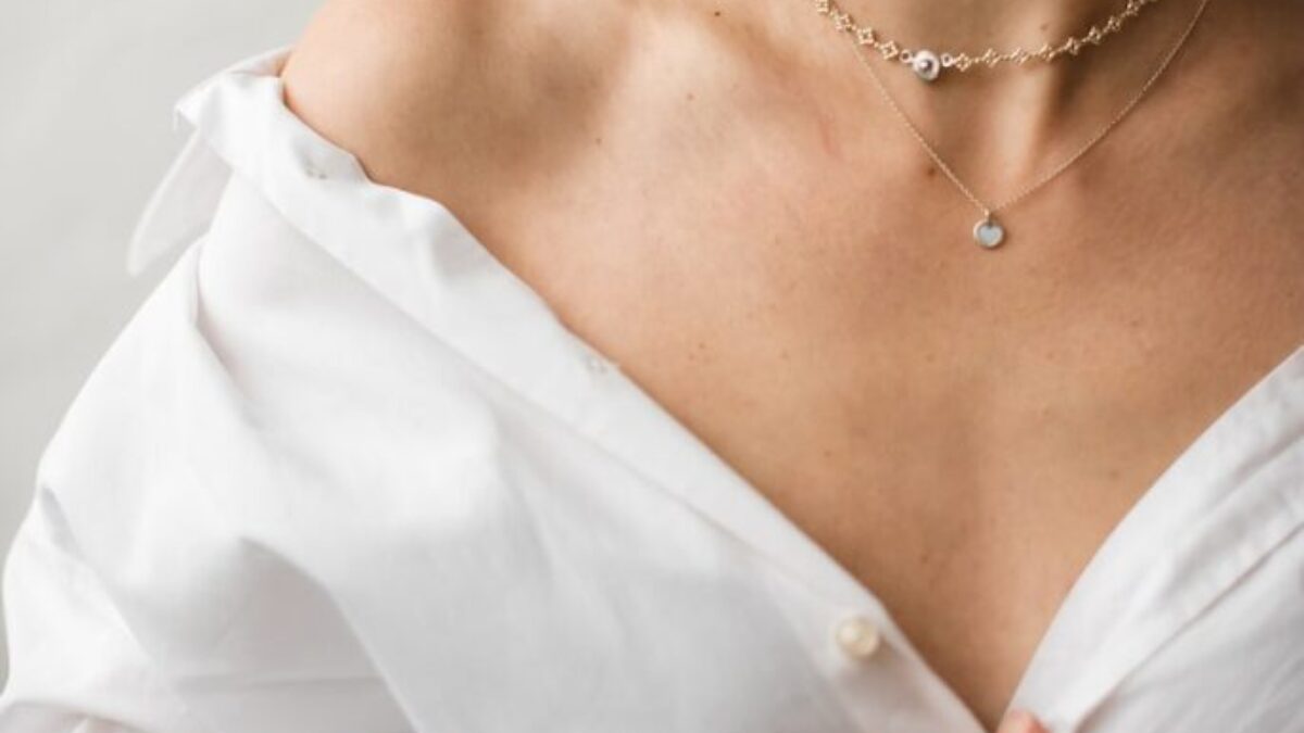 woman in white dress shirt wearing silver necklace