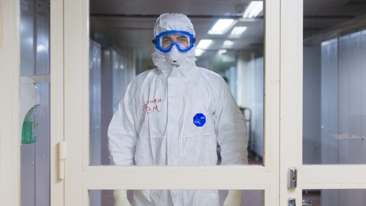 person in white jacket wearing blue goggles