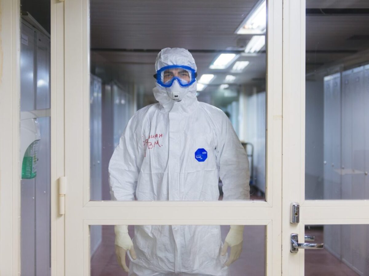 person in white jacket wearing blue goggles