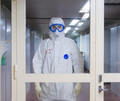 person in white jacket wearing blue goggles