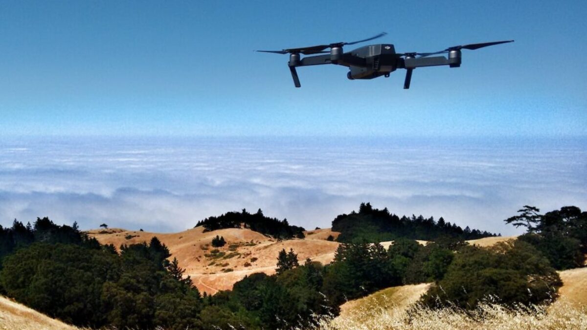 black drone on air over cloudy sky at daytime