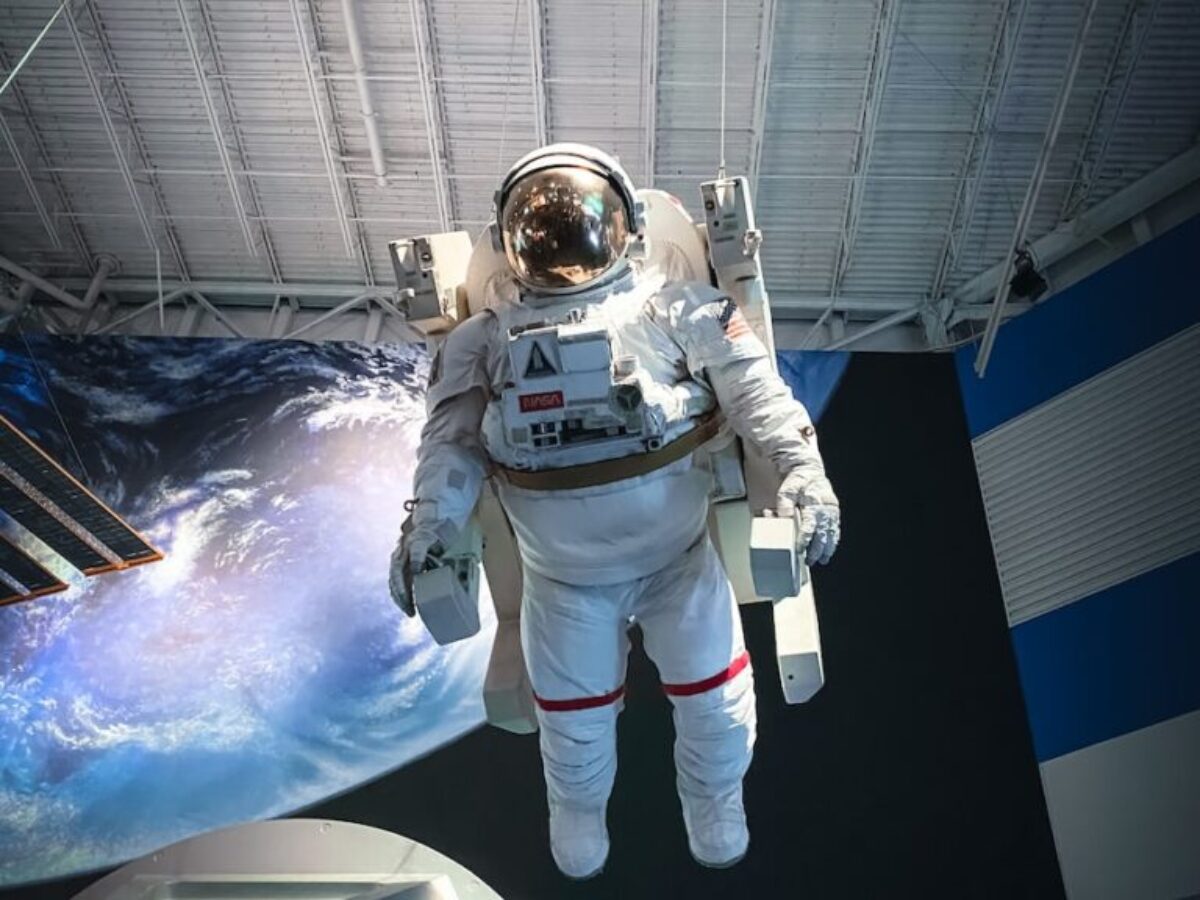 man in white and black suit standing on white and blue floor