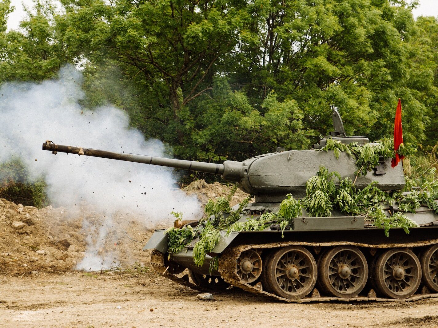 green battle tank on brown soil