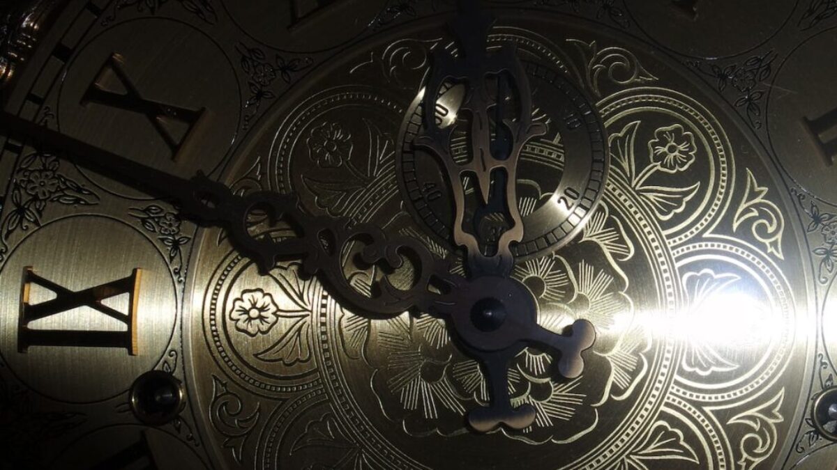 brass-colored analog clock