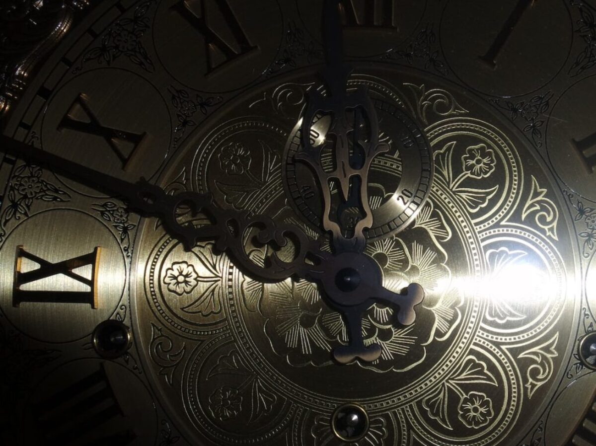 brass-colored analog clock