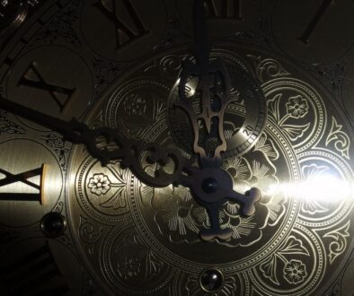 brass-colored analog clock