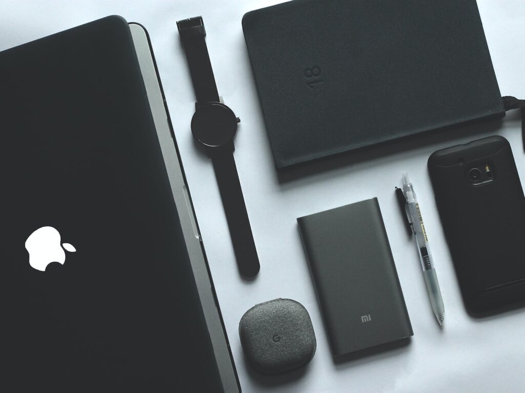 black MacBook, watch, smartphone and notebook