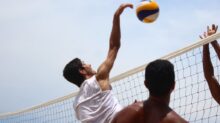 man in white shorts playing volleyball during daytime
