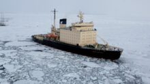 cargo ship on iced body of water
