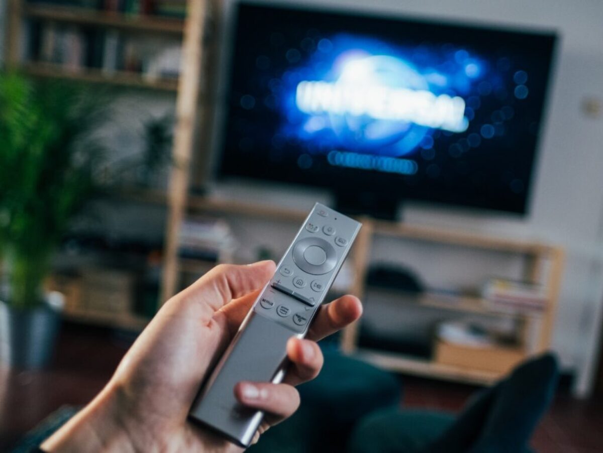person holding gray remote control