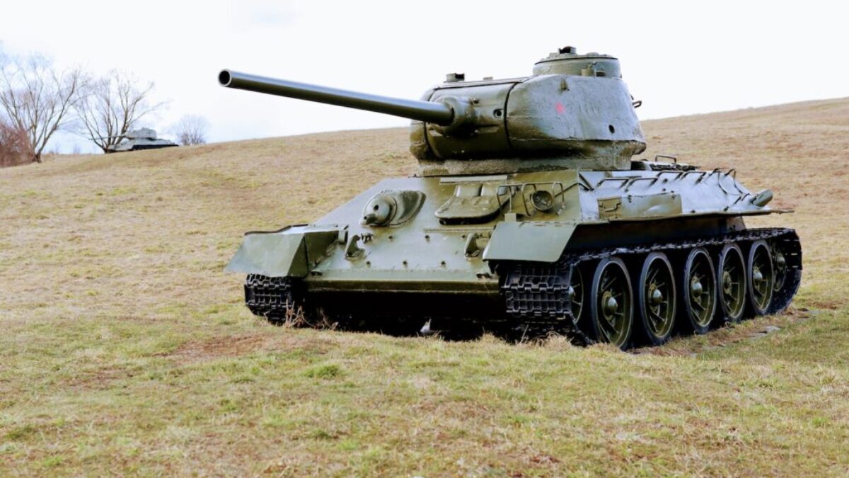 green battle tank on green grass field during daytime